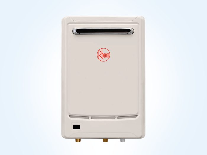 Plumber installing a continuous flow hot water unit