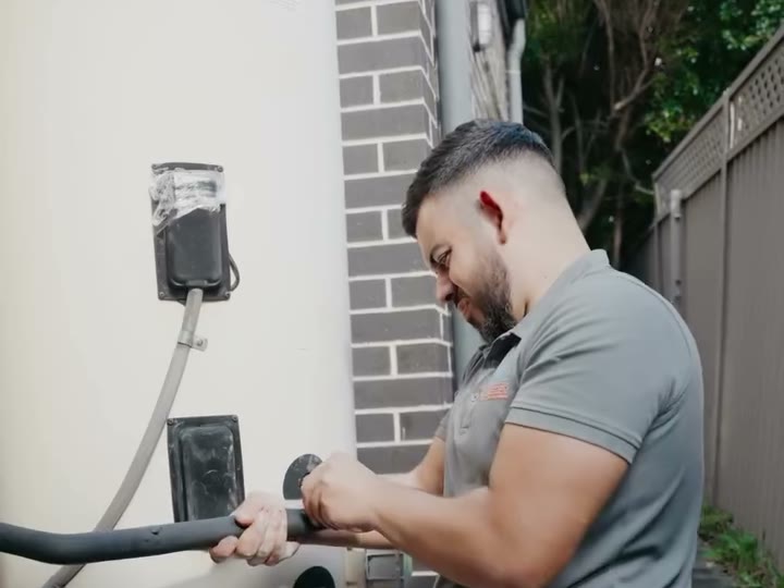 Plumber servicing a hot water system